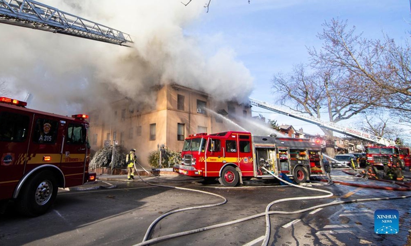 Firefighters work to extinguish a fire burning at an apartment building in Toronto, Canada, on Jan. 15, 2022.Photo:Xinhua